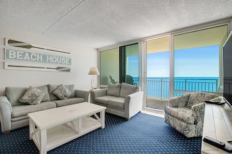 Beachfront condo with balcony, A/C, pool, sauna, & game room