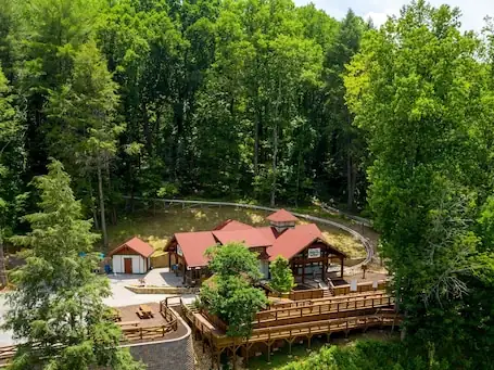 Peaceful wooded setting – Short Walk to Downtown! New Hot Tub and Roku tv.