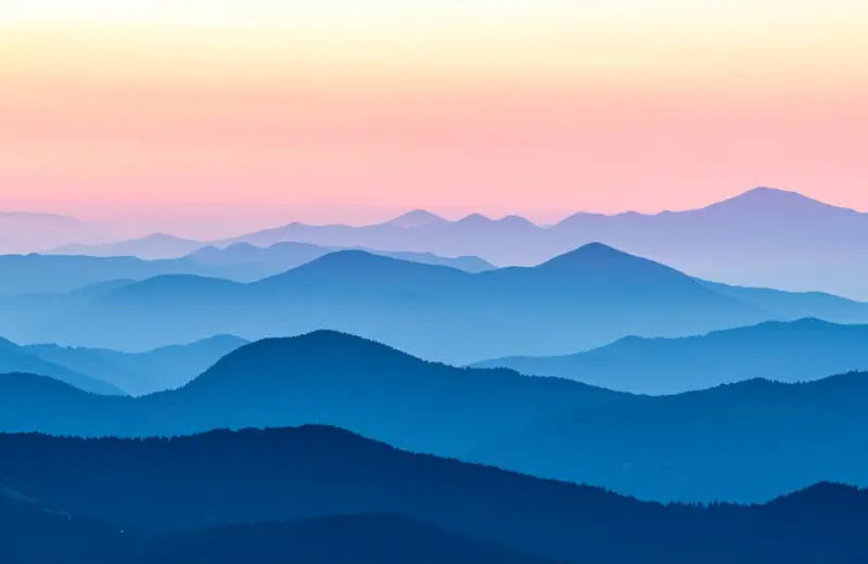 Misty pink and blue mountain layers at dawn in the Blue Ridge near Asheville