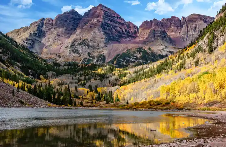 Maroon Bells near Aspen with golden fall aspens reflected in the lake