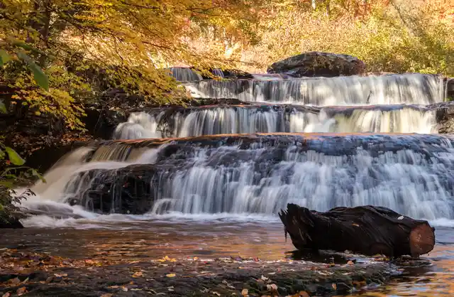 A tiered waterfall through autumn forest in the Pocono Mountains