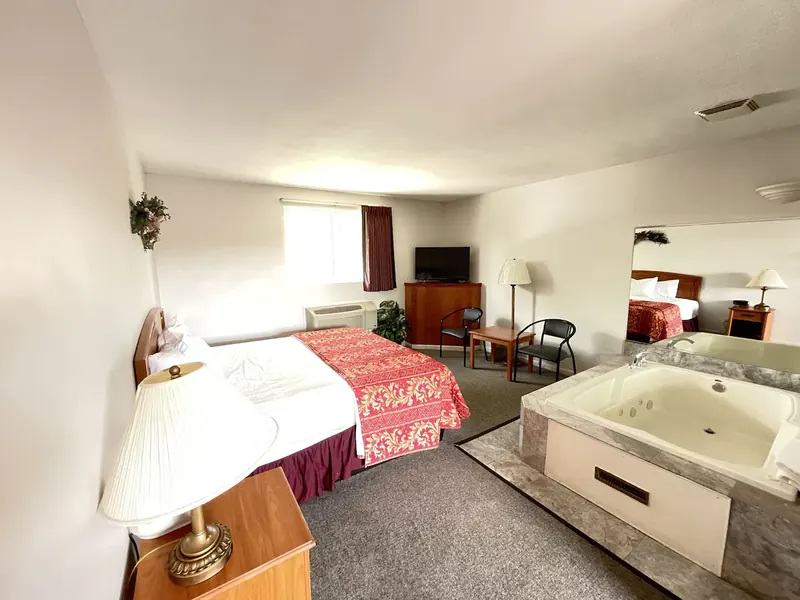Whirlpool suite with a private jetted tub beside the bed