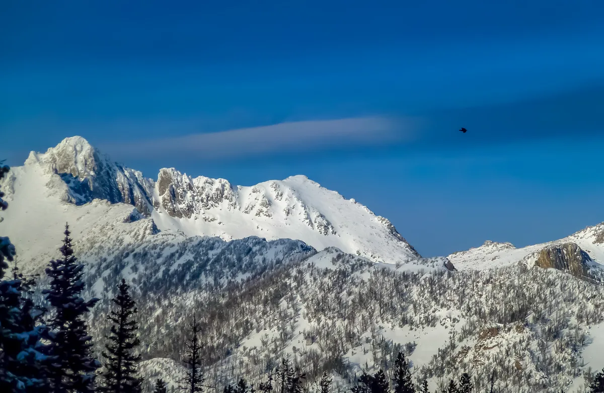 Snowy mountain ski country under a clear sky