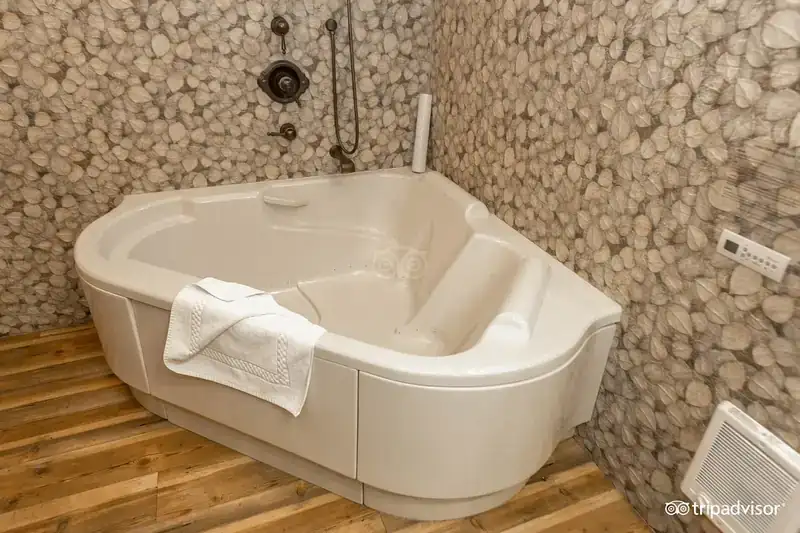 A pebble-tiled jacuzzi tub in a rustic room at Cedar Glen Lodge in Tahoe Vista.