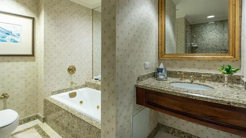 An elegant jacuzzi bathroom with a gold-framed mirror at Hotel Monteleone in New Orleans.